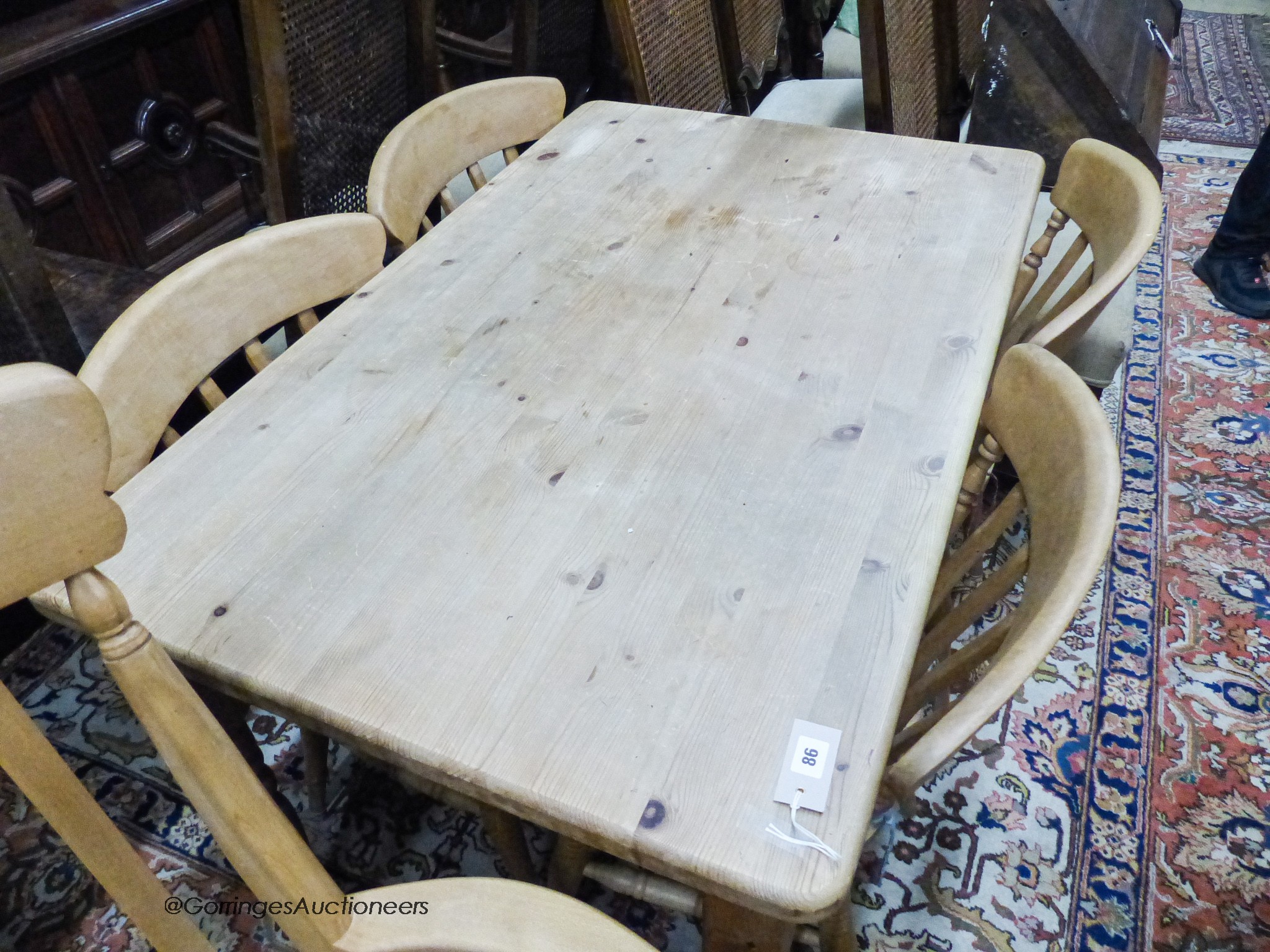 A small Victorian style rectangular pine kitchen table, width 120cm, depth 76cm, height 77cm together with a Windsor beech armchair and two kitchen chairs